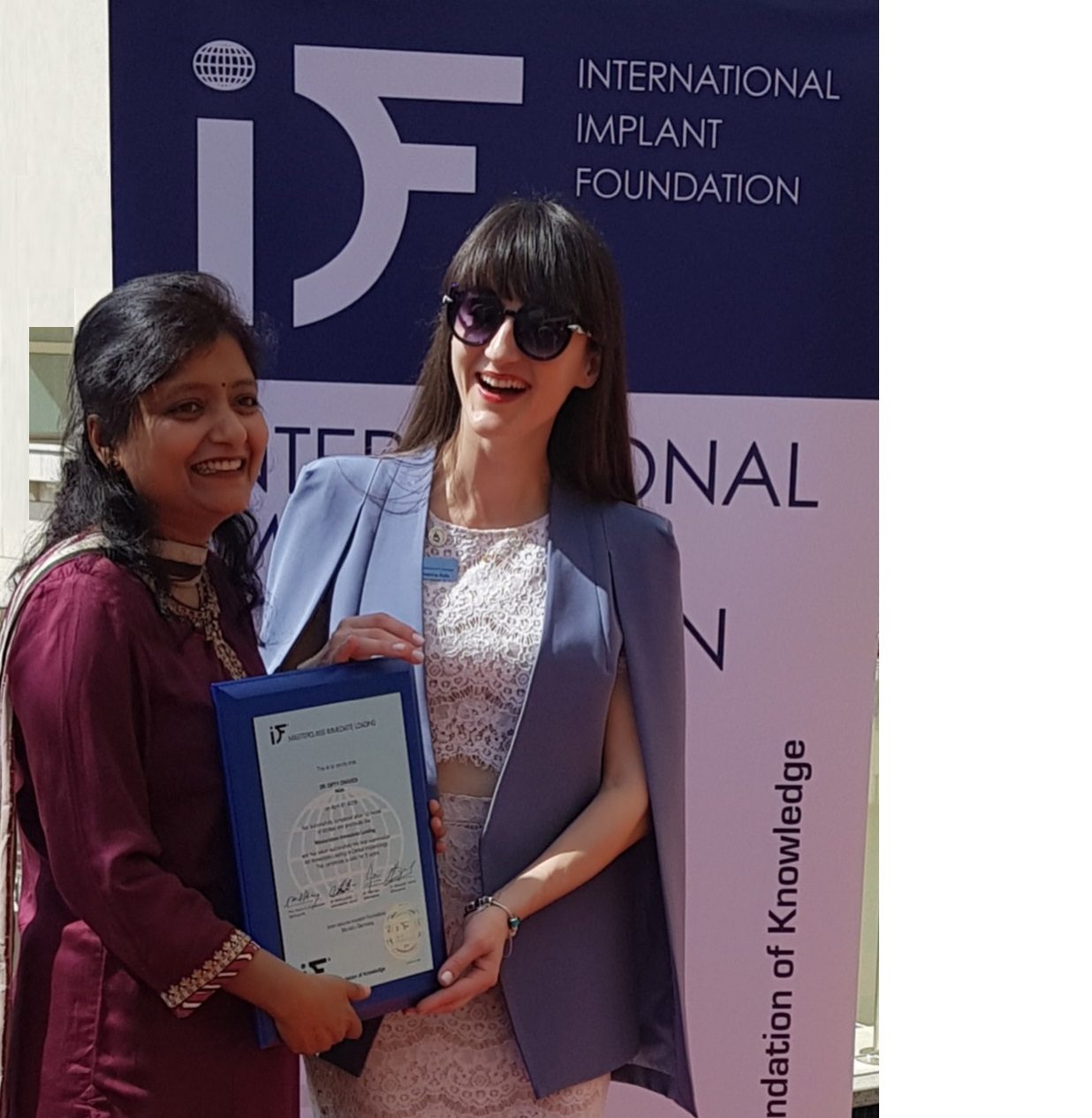 Dr. Dipty Dwivedi receiving her implantology certification from the International Implant Foundation