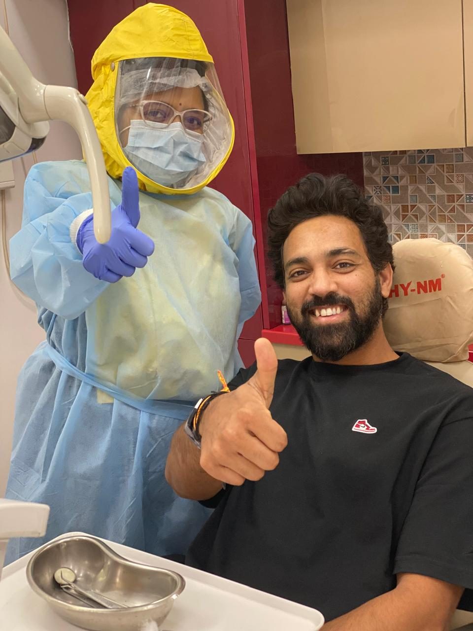Swapnil Singh giving a thumbs-up with Dr. Dipty after his tooth-pain treatment